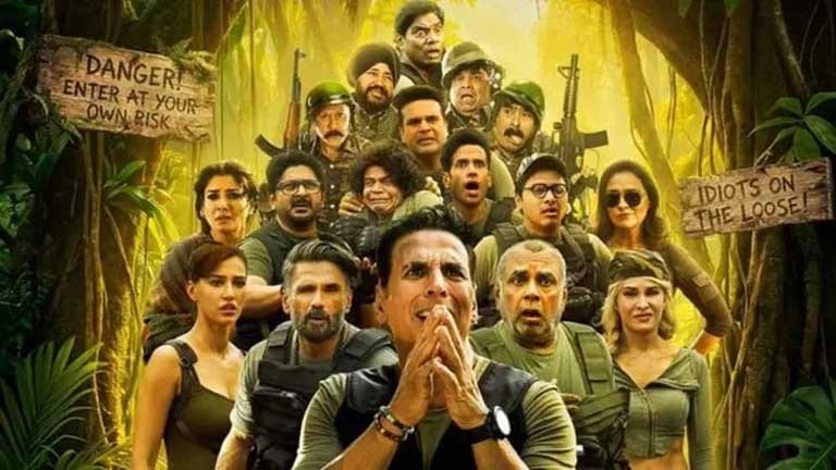 फिल्म वेलकम टू द जंगल के पोस्टर में मुख्य अभिनेता अक्षय कुमार और अन्य सह-कलाकार हंसते हुए, जो फिल्म के 100 करोड़ बॉक्स ऑफिस कलेक्शन की सफलता को दर्शाता है।