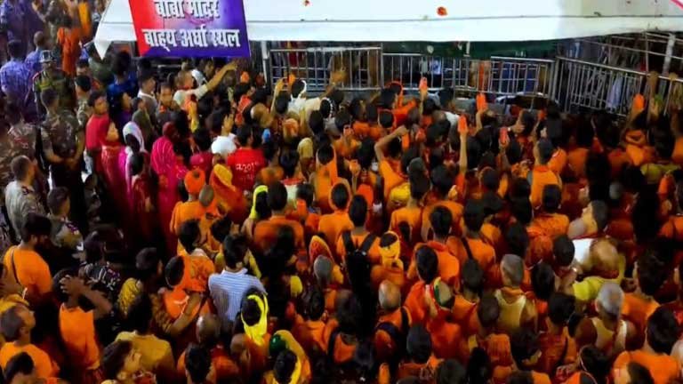 देवघर के बाबा बैद्यनाथ धाम में सावन की पहली सोमवारी पर जलाभिषेक के लिए कतार में खड़े केसरिया वस्त्र धारी कांवरियों और श्रद्धालुओं की भारी भीड़